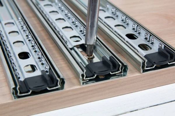 Metal sliding strips for furniture drawers. Furniture assembly.