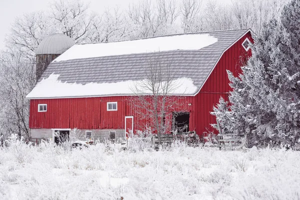 Red rustic barn in winter, covered in rime ice - taken in Minnesota