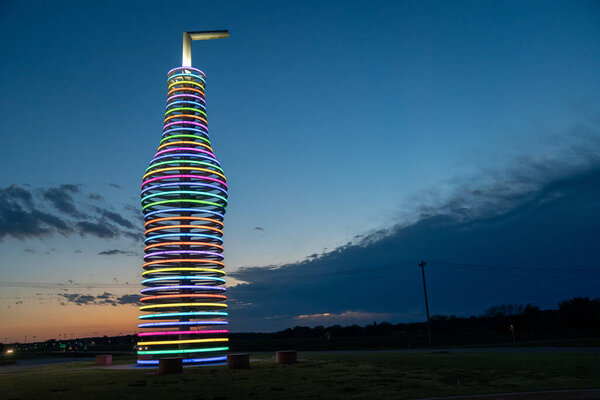Arcadia, Oklahoma - May 5, 2021: Pops Route 66, home of the worlds largest sculpture pop bottle. It lights up with neon lights at night