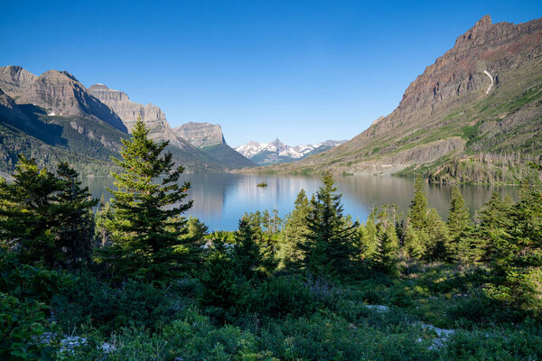 Wild Goose Island in Glacier National Park, on a sunny day with calm water
