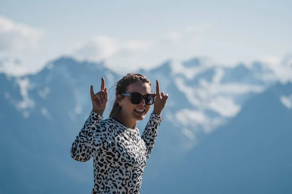 Adult woman shows the peace sign at Hurricane Ridge in Olympic National Park