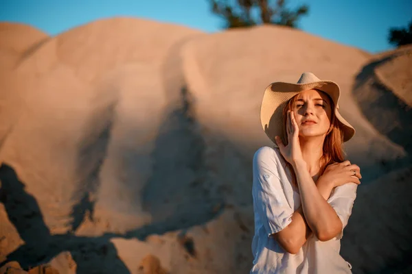 Dunas y líneas, paisaje escénico. Antecedentes del desierto arenoso y montañoso. Mujer joven sentada y mirando las dunas. — Foto de Stock