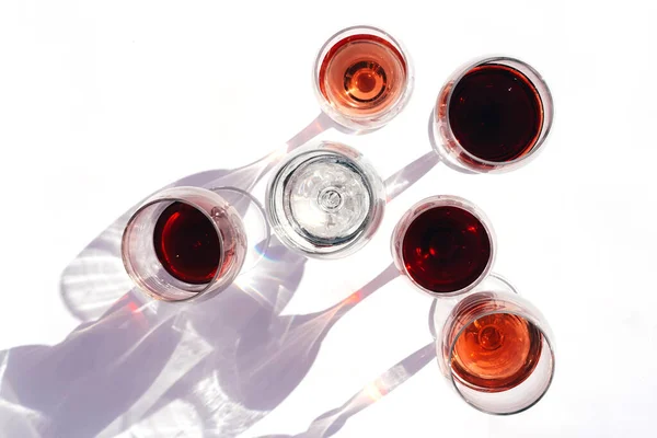 Víno různých odrůd v brýlích na bílém pozadí. Stock Obrázky
