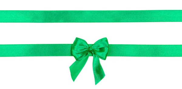 Green satin ribbon with a bow isolated on white background. — Stock Photo, Image