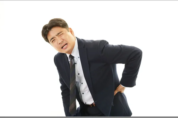 Businessman having back pain — Stock Photo, Image