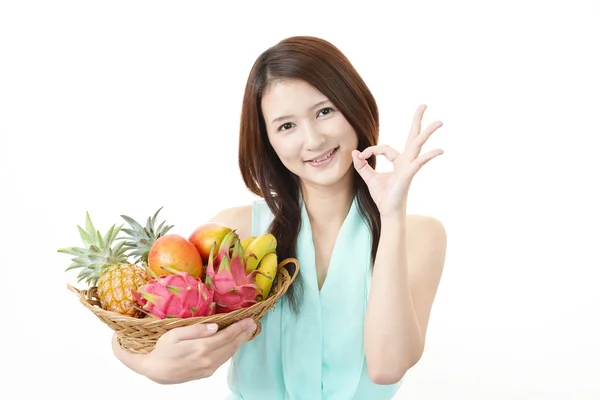 Smiling woman with fruits. — Stock Photo, Image