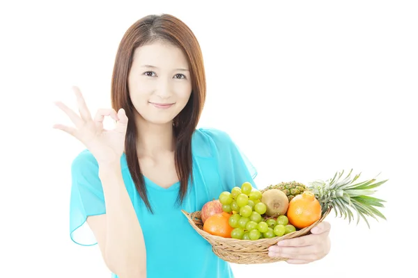 Smiling woman with fruits. — Stock Photo, Image