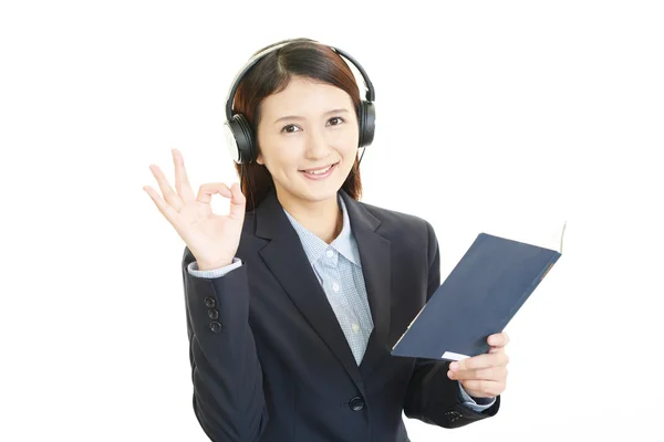 Attractive young Asian woman listening to music. — Stock Photo, Image