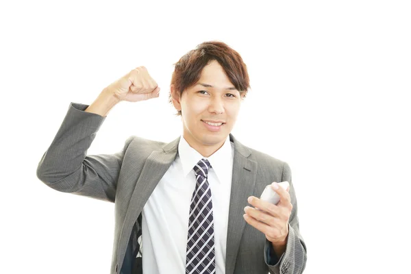 Happy businessman holding smart phone — Stock Photo, Image