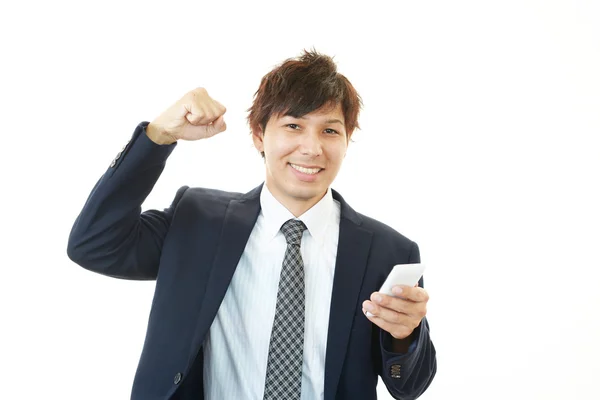 Happy businessman holding smart phone — Stock Photo, Image