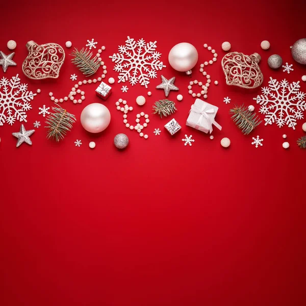 Christmas border of white decorations pattern on red copy space background.