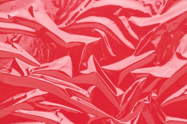 Kırışık yapışkan film, kırmızı vinil soyut arkaplan.