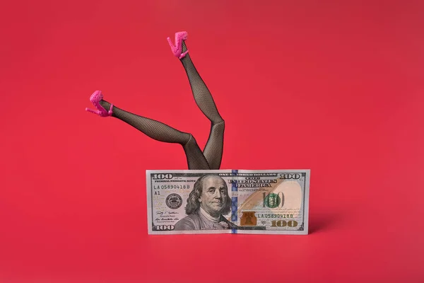 Sexy woman legs in black fishnet stockings over dollar bill, Sex for money concept. Royalty Free Stock Images