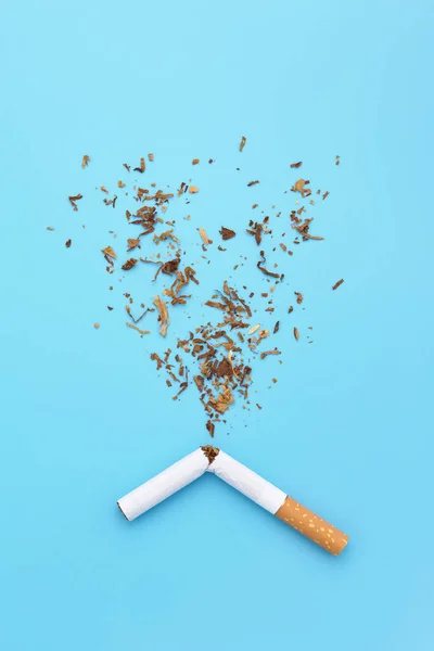 A broken cigarette and tobacco splash for quit smoking concept. Royalty Free Stock Photos