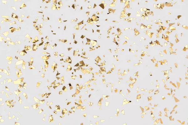 Gold confetti sparkles on white background, golden foil, festive backdrop. Royalty Free Stock Images