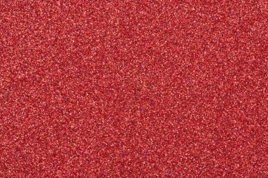 Parlak kırmızı kağıt dokusu. Pürüzsüz soyut bir arkaplan. Tasarım için ışıltı örtüsü, yakın plan.