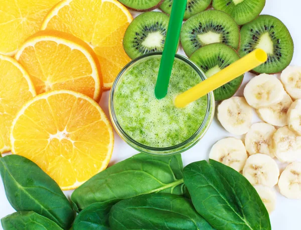 green smoothie with spinach, kiwi, bananas and oranges in a jar