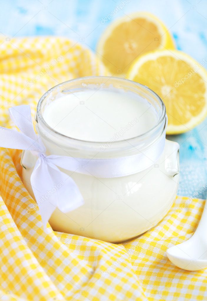 Homemade yogurt in small glass jar on a blue table, selective fo — Stock Photo © Fieryphoenix