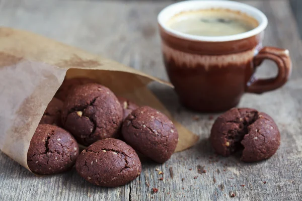 Italian chocolate cookies with walnuts and a cup of coffee on a