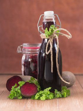 Beetroot in the glass and beetroot juice in a bottle clipart