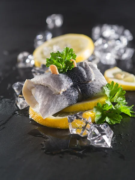 Rollmop herring on lemon slices — Stock Photo, Image
