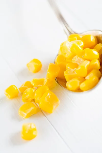 Sweet corn from from a spoon — Stock Photo, Image