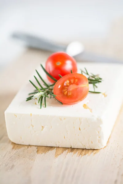 Feta lies on a wooden board — Stock Photo, Image