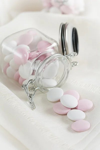 Chocolate lenses fall of a glass — Stock Photo, Image