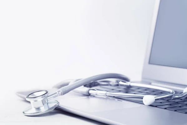 Stethoscope on a laptop. Virus season, pandemic. Remote medicine or elearning and telemedicine and consultation advice. Copy space. Medical network