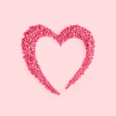 Kalp şeklinde şeker pembe kalpler. Fotokopi odası, feminen blogcu ya da bayramlık aşk hediyesi ve Sevgililer Günü konseptiyle düzlükte serpiştirilmiş kek parçacıkları. Afiş modeli. Küçük kalpler.