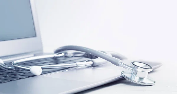 Stethoscope on a laptop. Virus season, pandemic. Remote medicine or elearning and telemedicine and consultation advice. Copy space. Medical network or contact us banner