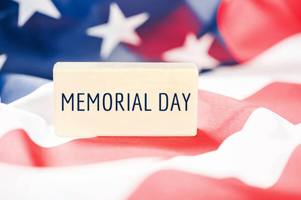 Memorial Day text over American flag banner. US rememberance Day background