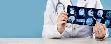 Female doctors hand pointing at x-ray or MRI medical imaging with a head and neck condition. Spinal cord, blood vessels. Neuro medicine. Healthcare and medicine. Brain tissues. Banner copy space clipart