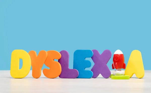 Dyslexia Word Multicolored Letters Wooden Desk Blue Background Reading Difficulty — Stock Photo, Image