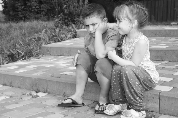 Summer outdoor girl comforting a sad boy. Black and white photo. — Stock Photo, Image