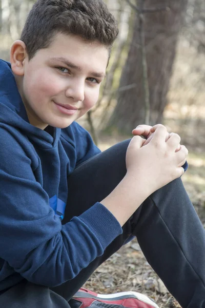 Einem Sonnigen Frühlingstag Sitzt Ein Glücklicher Junge Wald Nahaufnahme — Stockfoto