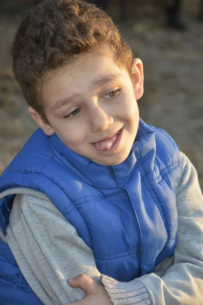 Little boy indulges shows tongue. — Stock Photo, Image