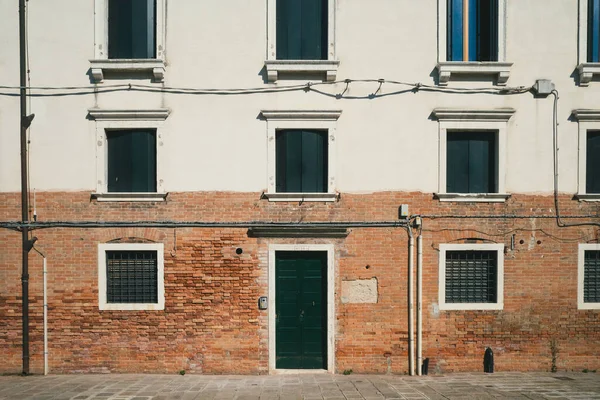 Wall with door and windows of a traditional Venetian houses in Venice, Italy
