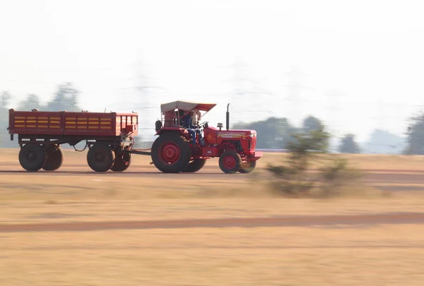 Couple of people in running Tractor — Stock Fotó