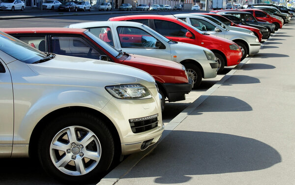 Cars are along the road on a sunny day