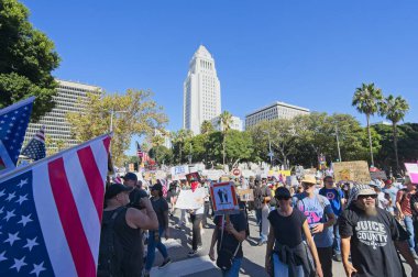 Los Angeles, Kaliforniya, ABD, 18 Ekim 2025. Protestocular, Krallar Yok kampanyası sırasında, Trump yönetim politikalarını protesto eden, demokrasi ve göçmen haklarına destek veren bayraklar ve pankartlar taşıyorlar..
