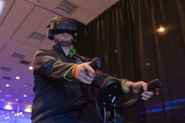 Man tries virtual reality headset and hand controls