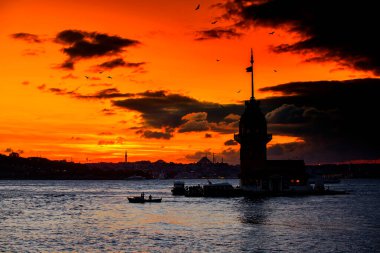 İstanbul, Türkiye 'nin sembolü Leander' s Tower olarak da bilinen ünlü Maiden 's Tower (Kiz Kulesi) ile Boğaz' ın üzerinde kızgın bir günbatımı. Duvar kağıdı veya rehber kitap için sahne yolculuğu arkaplanı