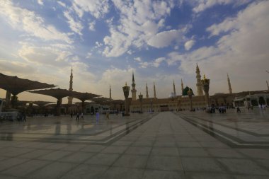 Medine Camii. Müslümanlar, Peygamber. Muhammed camisinin önünde büyük bir şemsiye altında oturdular. Medine, Suudi Arabistan