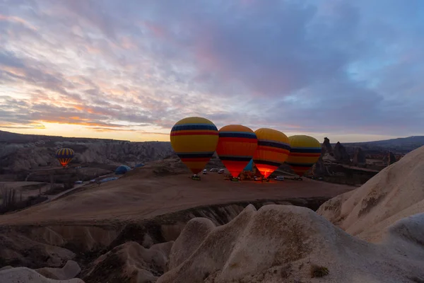Türkiye 'nin Kapadokya kentindeki sıradışı kayalık manzaraya yüzeysel bir bakış açısı. Kapadokya 'daki peri bacalarıyla mavi gökyüzünde renkli sıcak hava balonları uçuyor..