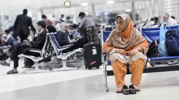 One woman at the airport awaiting departure