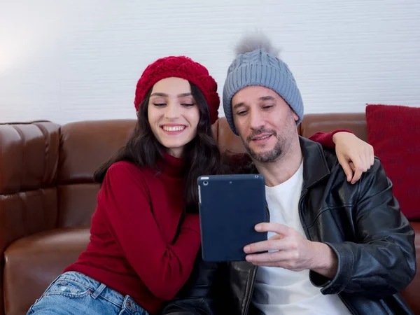 Couple using tablet video call at home