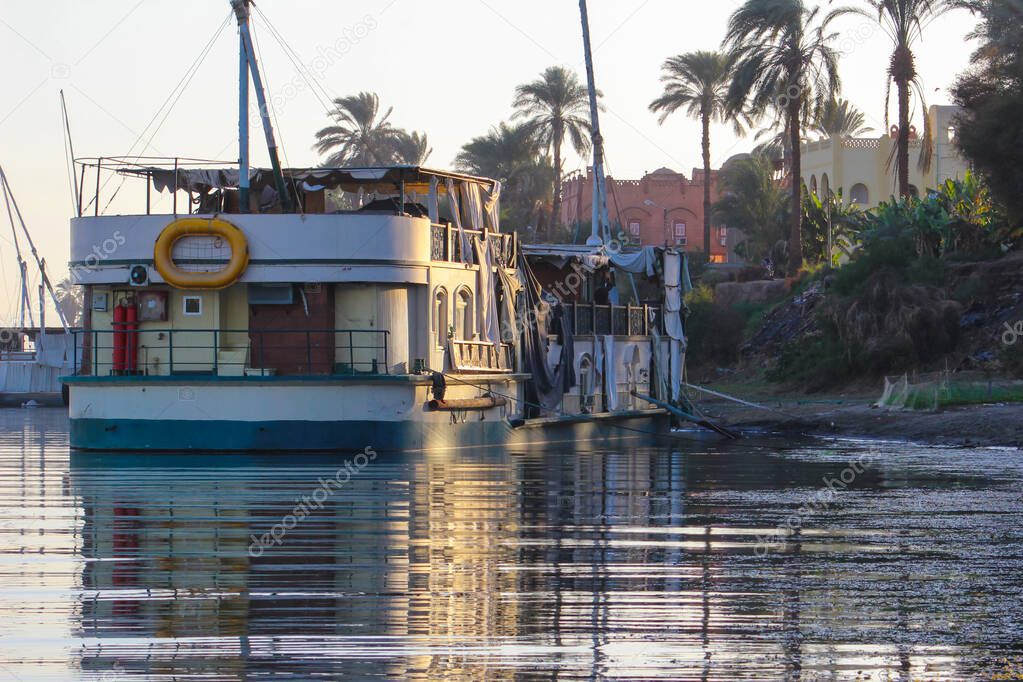 Traditional tourist boats on the Nile, Egypt. Reflection in water