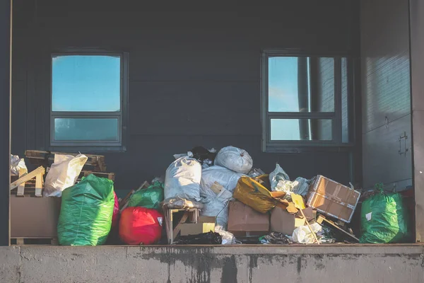 Garbage bags and boxes on the loading dock. Waste removal