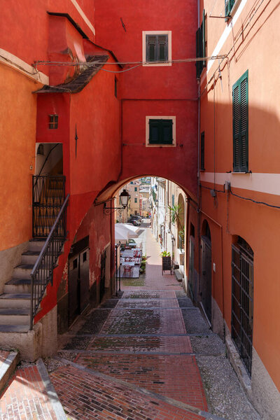 Typical Italian narrow street in Imperia old town, Liguria region, Italy